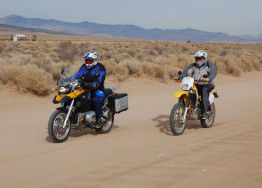 A BMW R1200GS rides next to a Suzuki DR350