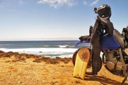 Carrying a surfboard on your motorcycle.