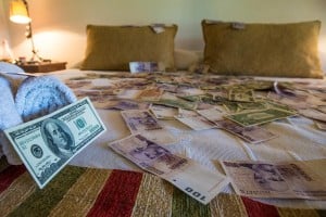 Cash on the bed in different currencies.